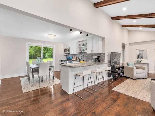 18731 John Ave, Country Club Hills, IL 60478 - kitchen featuring appliances with stainless steel finishes, open shelves, a peninsula, white cabinetry, and a breakfast bar area