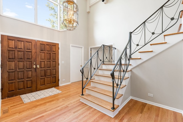 3528 Riverside Dr, Wilmette, IL 60091 - foyer entrance featuring a high ceiling, a chandelier, stairs, and light wood-style floors