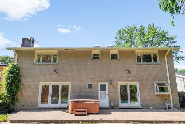 3528 Riverside Dr, Wilmette, IL 60091 - back of property with a hot tub, a patio area, and brick siding