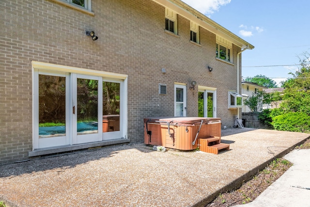 3528 Riverside Dr, Wilmette, IL 60091 - back of property with a hot tub, a patio area, and brick siding
