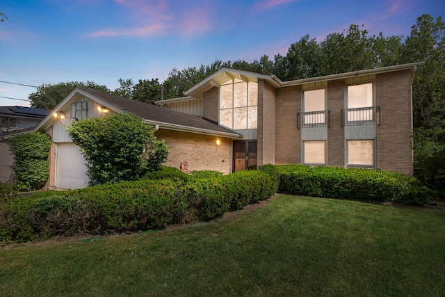 3528 Riverside Dr, Wilmette, IL 60091 - view of front of house with brick siding, an attached garage, and a lawn