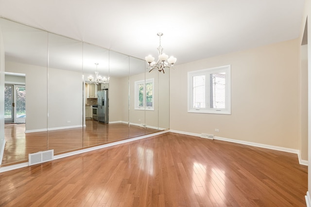 3528 Riverside Dr, Wilmette, IL 60091 - unfurnished dining area with a chandelier and light wood-style flooring