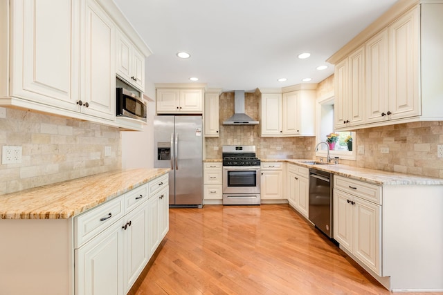 3528 Riverside Dr, Wilmette, IL 60091 - kitchen with appliances with stainless steel finishes, wall chimney range hood, decorative backsplash, light stone counters, and recessed lighting