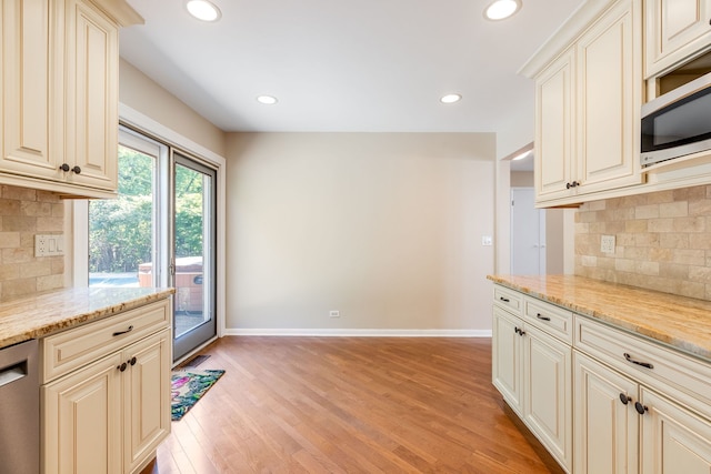 3528 Riverside Dr, Wilmette, IL 60091 - kitchen featuring stainless steel appliances, tasteful backsplash, light wood-type flooring, recessed lighting, and light stone counters