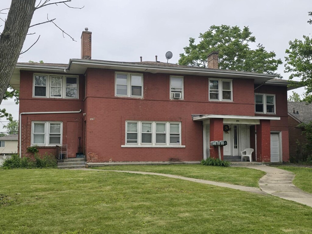 378 W 16th St, Chicago Heights, IL 60411 - view of front facade with a chimney, brick siding, and a front yard