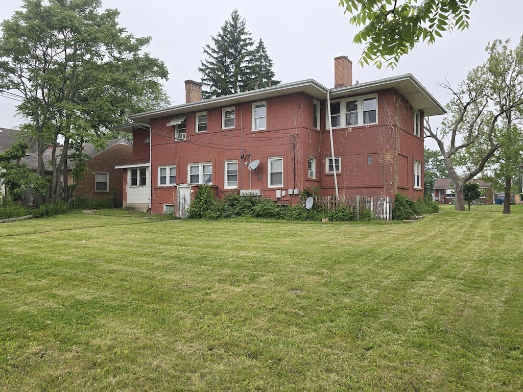 378 W 16th St, Chicago Heights, IL 60411 - back of property featuring a chimney and a yard