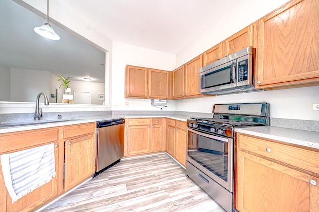 1471 Doolittle Ln, Grayslake, IL 60030 - kitchen with stainless steel appliances, light wood-style floors, hanging light fixtures, and light brown cabinetry