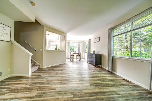 1471 Doolittle Ln, Grayslake, IL 60030 - unfurnished living room with wood finished floors, stairway, and a chandelier