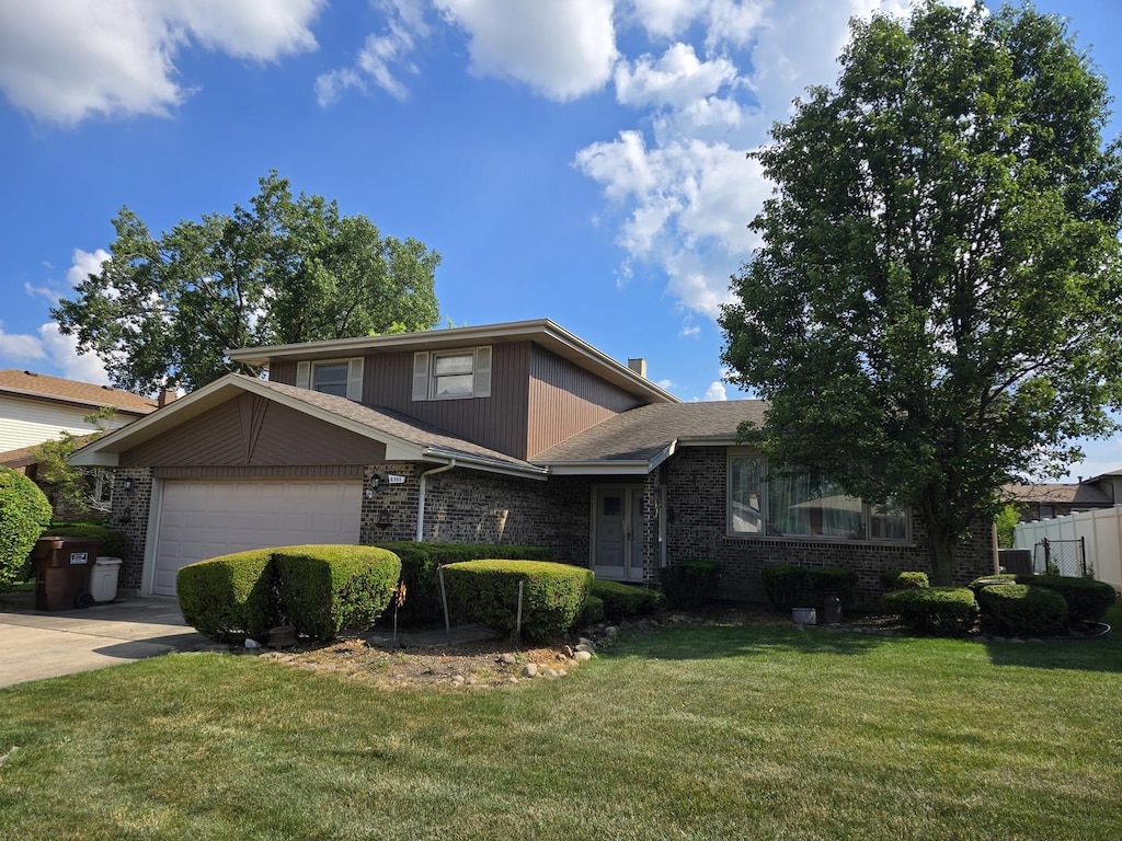 6305 157th St, Oak Forest, IL 60452 - tri-level home with brick siding, concrete driveway, and a garage