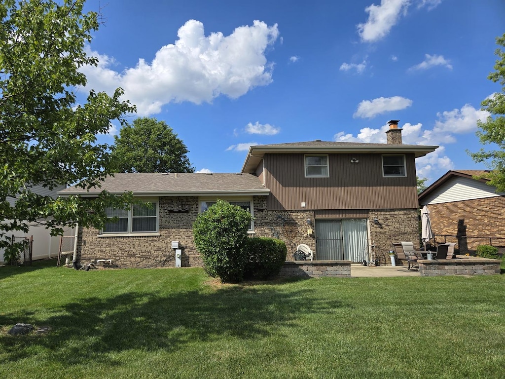 6305 157th St, Oak Forest, IL 60452 - rear view of property with a chimney, a patio, and a fire pit