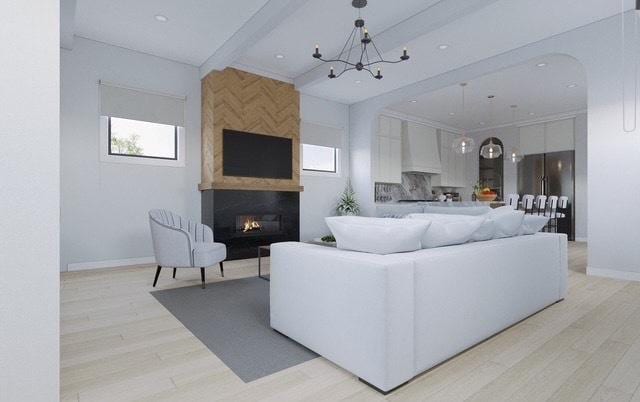 2203 W Huron Ave, Chicago, IL 60622 - living area featuring light wood-style flooring, a fireplace, arched walkways, and a chandelier