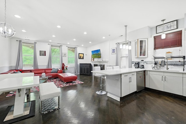 4105 S Drexel Blvd Unit 1N, Chicago, IL 60653 - kitchen featuring stainless steel dishwasher, a peninsula, healthy amount of natural light, white cabinets, and recessed lighting