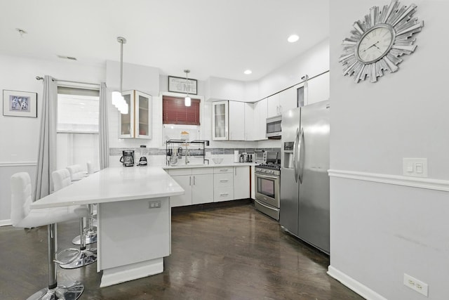 4105 S Drexel Blvd Unit 1N, Chicago, IL 60653 - kitchen featuring appliances with stainless steel finishes, a peninsula, glass insert cabinets, white cabinets, and light countertops