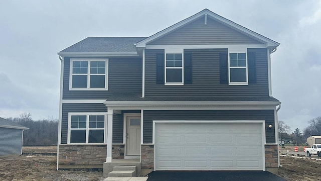 13717 S Sanibel St, Plainfield, IL 60544 - view of front of home with stone siding, an attached garage, and driveway
