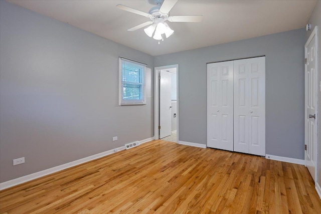 unfurnished bedroom featuring light wood-type flooring, a closet, and ceiling fan