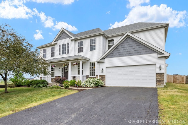 854 Preston Ln, Oswego, IL 60543 - view of front facade with a porch, asphalt driveway, stone siding, and an attached garage