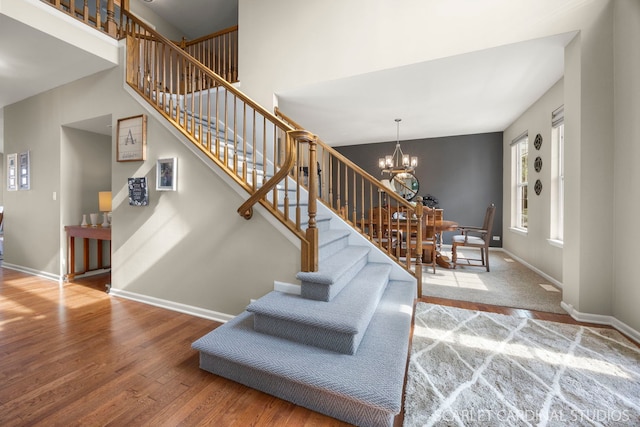854 Preston Ln, Oswego, IL 60543 - stairway with wood finished floors and a chandelier