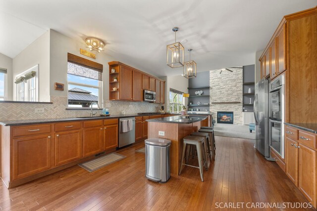 854 Preston Ln, Oswego, IL 60543 - kitchen featuring appliances with stainless steel finishes, open shelves, dark countertops, and healthy amount of natural light