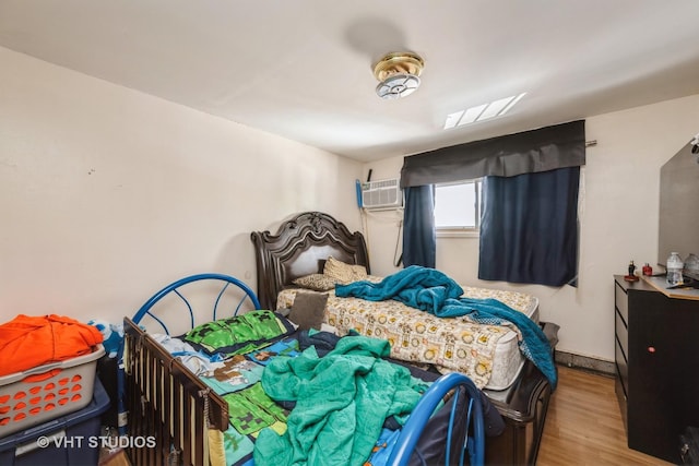 1107 E Algonquin Rd Unit 19, Arlington Heights, IL 60005 - bedroom featuring a wall mounted air conditioner and wood finished floors