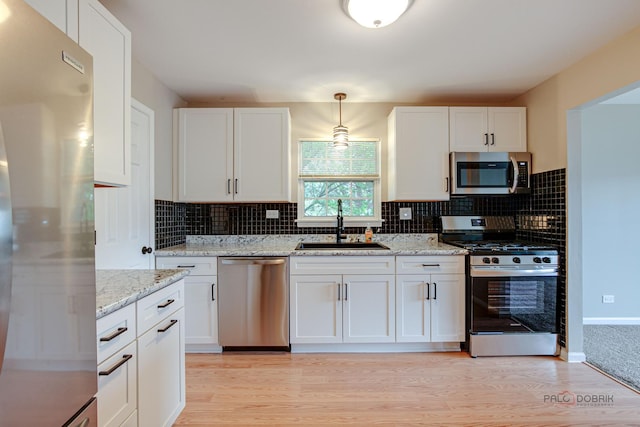 1186 Ballantrae Pl Unit D, Mundelein, IL 60060 - kitchen with appliances with stainless steel finishes, light wood-style flooring, and white cabinets