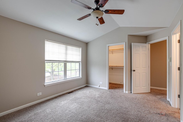 1186 Ballantrae Pl Unit D, Mundelein, IL 60060 - unfurnished bedroom featuring vaulted ceiling, carpet floors, a spacious closet, a closet, and ceiling fan