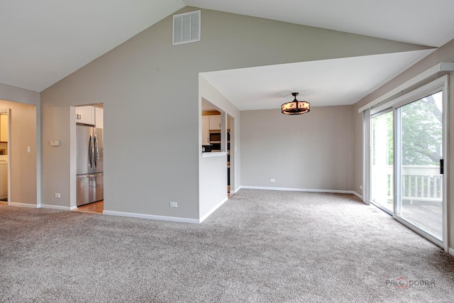 1186 Ballantrae Pl Unit D, Mundelein, IL 60060 - unfurnished living room with light carpet and high vaulted ceiling