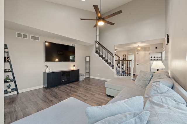 5462 Ridge Xing, Hanover Park, IL 60133 - living area featuring stairs, wood finished floors, a high ceiling, and a ceiling fan