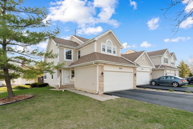 5462 Ridge Xing, Hanover Park, IL 60133 - view of front of house with driveway, a front lawn, roof with shingles, brick siding, and an attached garage