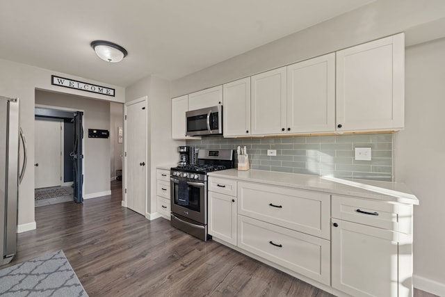 5462 Ridge Xing, Hanover Park, IL 60133 - kitchen featuring appliances with stainless steel finishes, light countertops, tasteful backsplash, and dark wood-style flooring