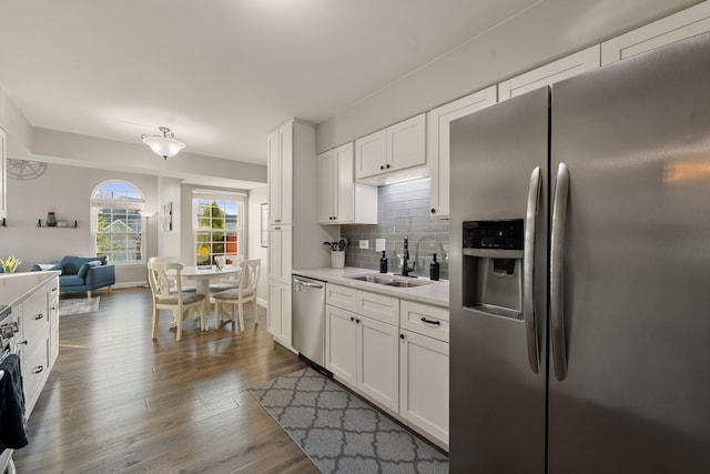 5462 Ridge Xing, Hanover Park, IL 60133 - kitchen featuring appliances with stainless steel finishes, light countertops, backsplash, white cabinetry, and dark wood finished floors