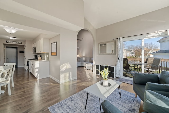 5462 Ridge Xing, Hanover Park, IL 60133 - living room featuring arched walkways and dark wood finished floors