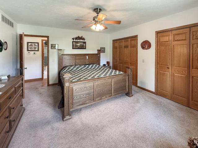 5782 N Brown Rd, Dakota, IL 61018 - bedroom with multiple closets, light carpet, and a ceiling fan