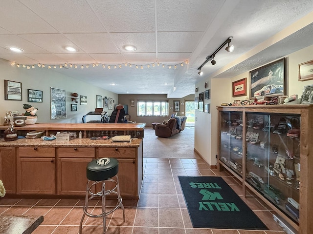 5782 N Brown Rd, Dakota, IL 61018 - kitchen featuring light tile patterned flooring, recessed lighting, a peninsula, open floor plan, and brown cabinets