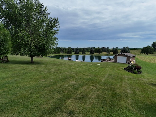 5782 N Brown Rd, Dakota, IL 61018 - view of green lawn with a water view and a detached garage
