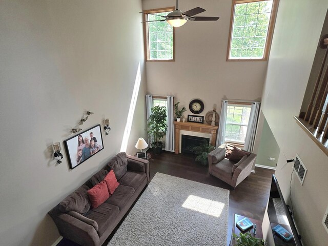 17207 Arrow Head Dr, Lockport, IL 60441 - living room with healthy amount of natural light, a towering ceiling, dark wood-style floors, a tile fireplace, and a ceiling fan