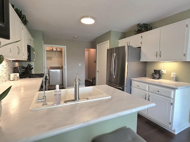 17207 Arrow Head Dr, Lockport, IL 60441 - kitchen with stainless steel appliances, washer / clothes dryer, light countertops, white cabinets, and decorative backsplash