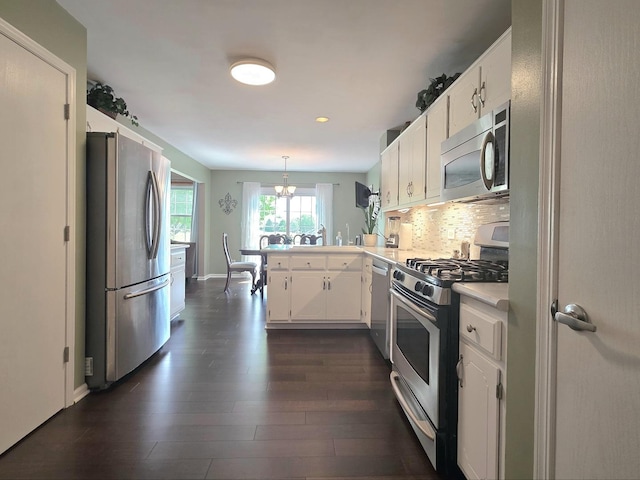 17207 Arrow Head Dr, Lockport, IL 60441 - kitchen featuring stainless steel appliances, a peninsula, dark wood finished floors, light countertops, and white cabinetry