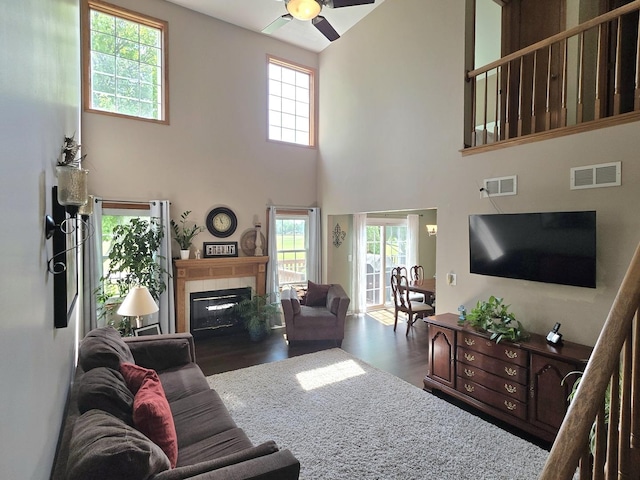 17207 Arrow Head Dr, Lockport, IL 60441 - living room featuring a fireplace with flush hearth, ceiling fan, wood finished floors, and a high ceiling