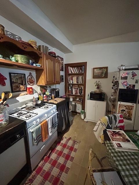 2431 W Thomas St, Chicago, IL 60622 - kitchen with white range with gas stovetop, brown cabinetry, and open shelves