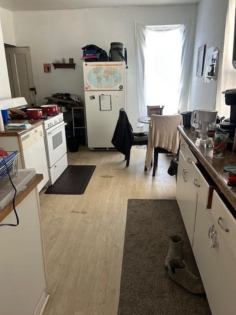 2431 W Thomas St, Chicago, IL 60622 - kitchen featuring white appliances, light wood-style floors, and white cabinetry