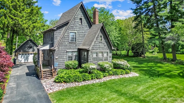 335 Arlington Rd, Itasca, IL 60143 - view of front of home featuring asphalt driveway, a chimney, a garage, a front yard, and an outbuilding