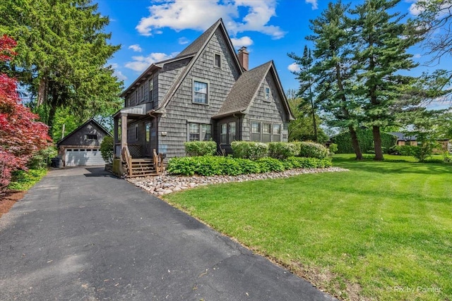 335 Arlington Rd, Itasca, IL 60143 - view of front of home featuring an outbuilding, a detached garage, a front lawn, and a chimney