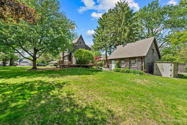 335 Arlington Rd, Itasca, IL 60143 - view of grassy yard with a storage shed and a wooden deck