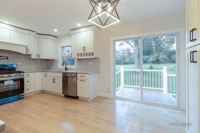 16705 Wolf Rd, Orland Park, IL 60467 - kitchen with stainless steel appliances, light countertops, decorative backsplash, light wood-type flooring, and white cabinetry