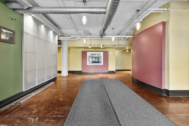 2323 W Pershing Rd Unit 212, Chicago, IL 60609 - hallway featuring finished concrete floors and baseboards