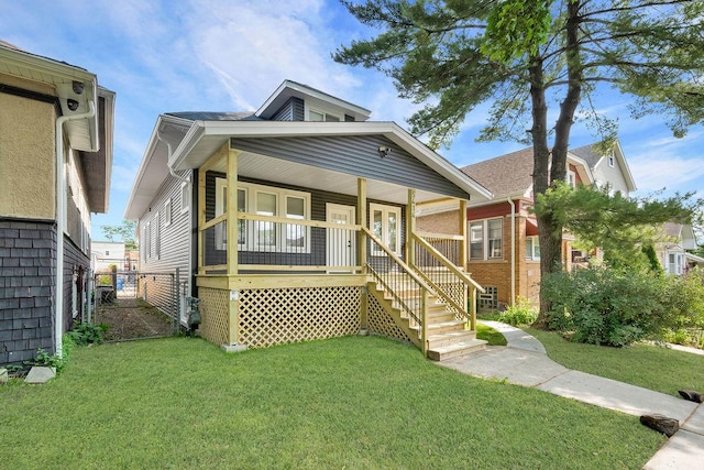 5414 W Haddon Ave, Chicago, IL 60651 - view of front facade featuring a front lawn, a porch, and stairs
