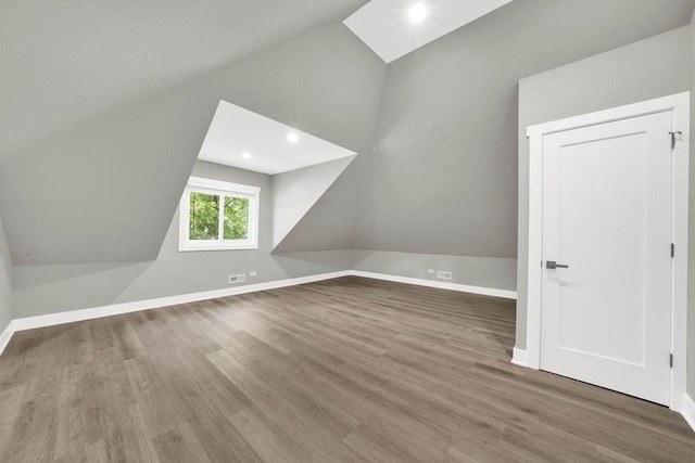 5414 W Haddon Ave, Chicago, IL 60651 - additional living space featuring vaulted ceiling, wood finished floors, and recessed lighting