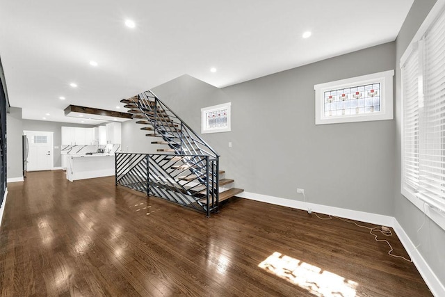 5414 W Haddon Ave, Chicago, IL 60651 - unfurnished living room featuring dark wood finished floors, stairs, and recessed lighting