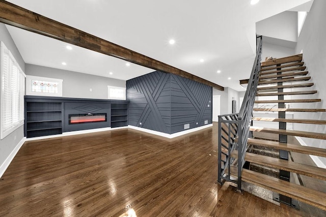 5414 W Haddon Ave, Chicago, IL 60651 - unfurnished living room with stairs, wood finished floors, a glass covered fireplace, a decorative wall, and recessed lighting