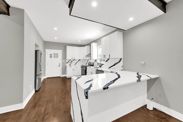 5414 W Haddon Ave, Chicago, IL 60651 - kitchen with appliances with stainless steel finishes, white cabinetry, light countertops, recessed lighting, and a peninsula